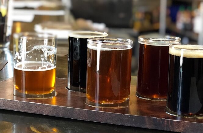 The Ultimate Denver Itinerary featured by top US family travel blog, More Than Main Street:  flight of beer at Wynkoop Brewery