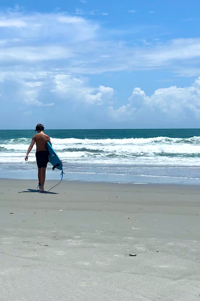 Teenager surfing at the beach