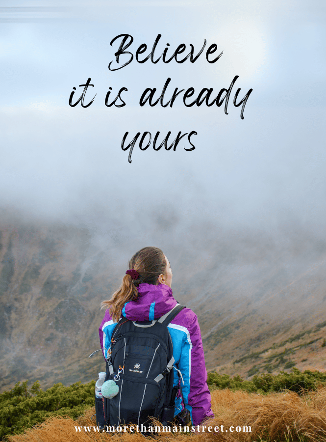 girl in a foggy mountain setting with text that reads "Believe it is already yours"