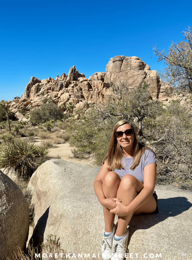 Woman sitting on giant rock in Joshua Tree National Park